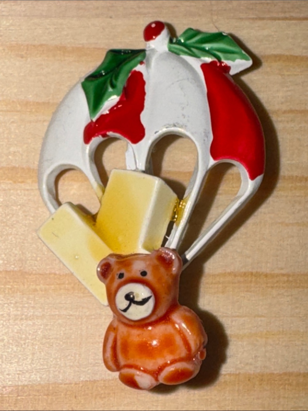 Vintage enameled novelty brooch depicting a teddy bear with a parachute